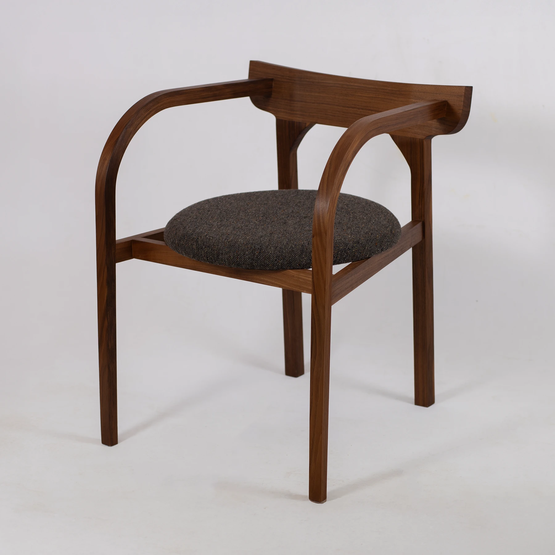 The walnut carver chair in British walnut with a round tweed upholstered seat