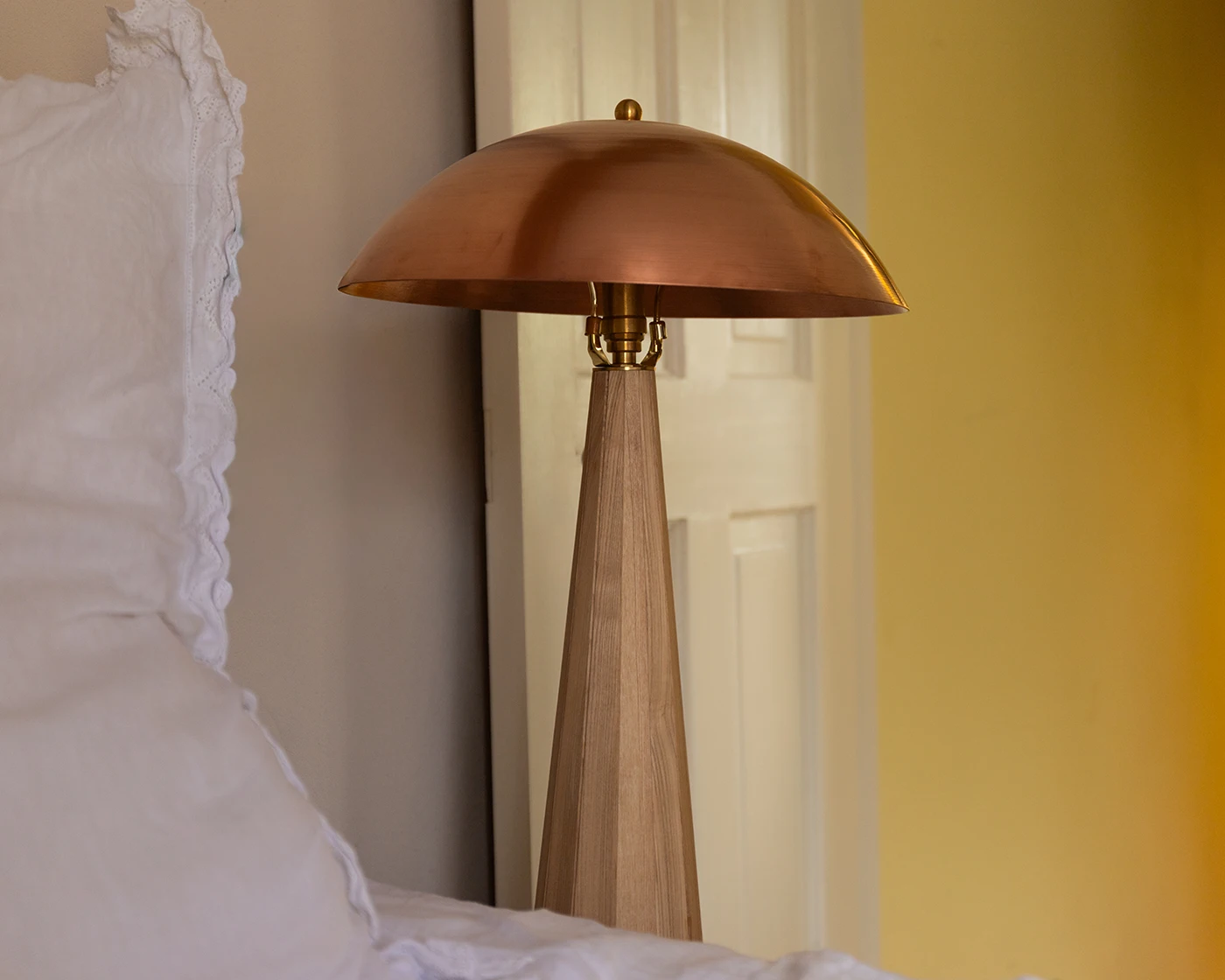 Close-up of hand-spun copper shade showing warm surface patina