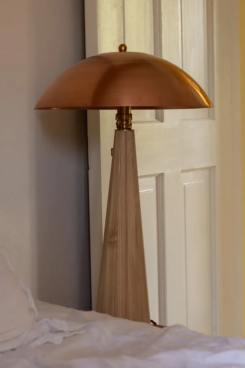 Close-up of hand-spun copper shade showing warm surface patina