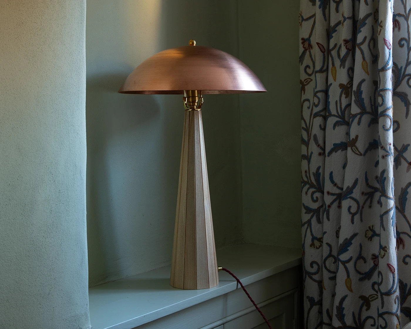 Copper lamp on side table in contemporary interior