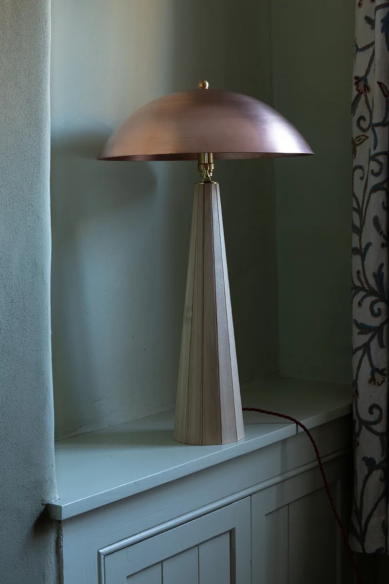 Copper lamp on side table in contemporary interior