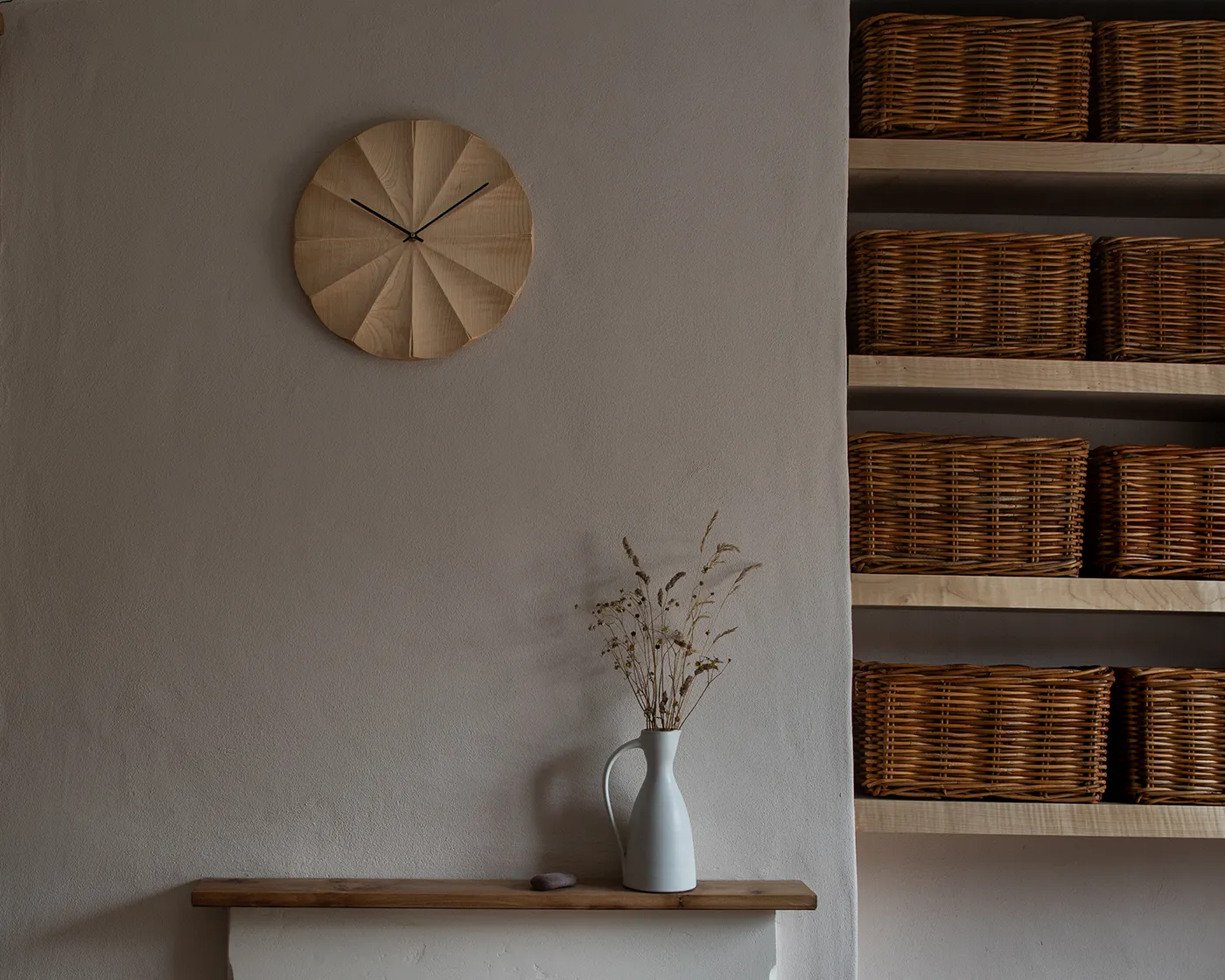 Fluted sycamore wall clock hanging on a wall
