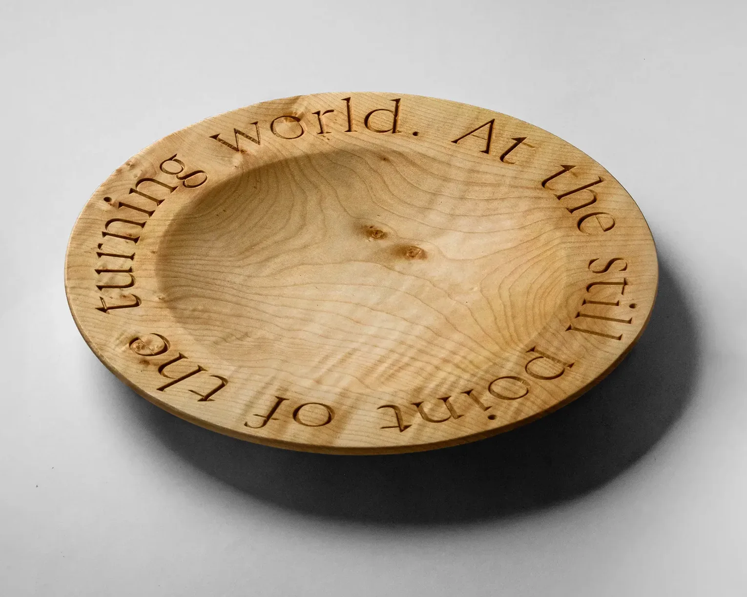 Quartet Bowl in English sycamore, showing v-groove inscribed lettering around the rim