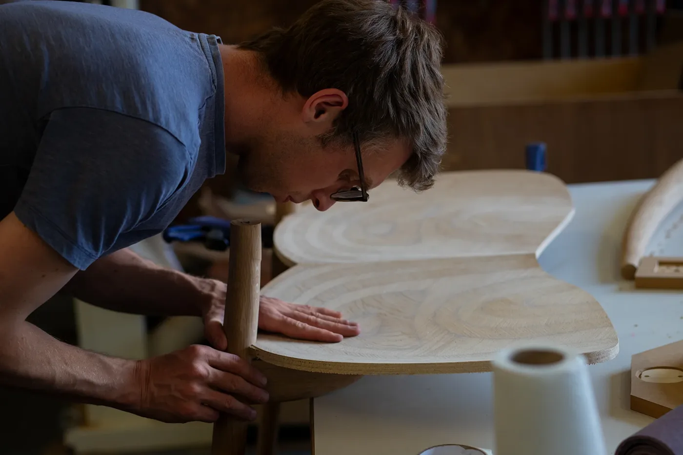 Furniture maker working on carved table detail at Oxfordshire workshop